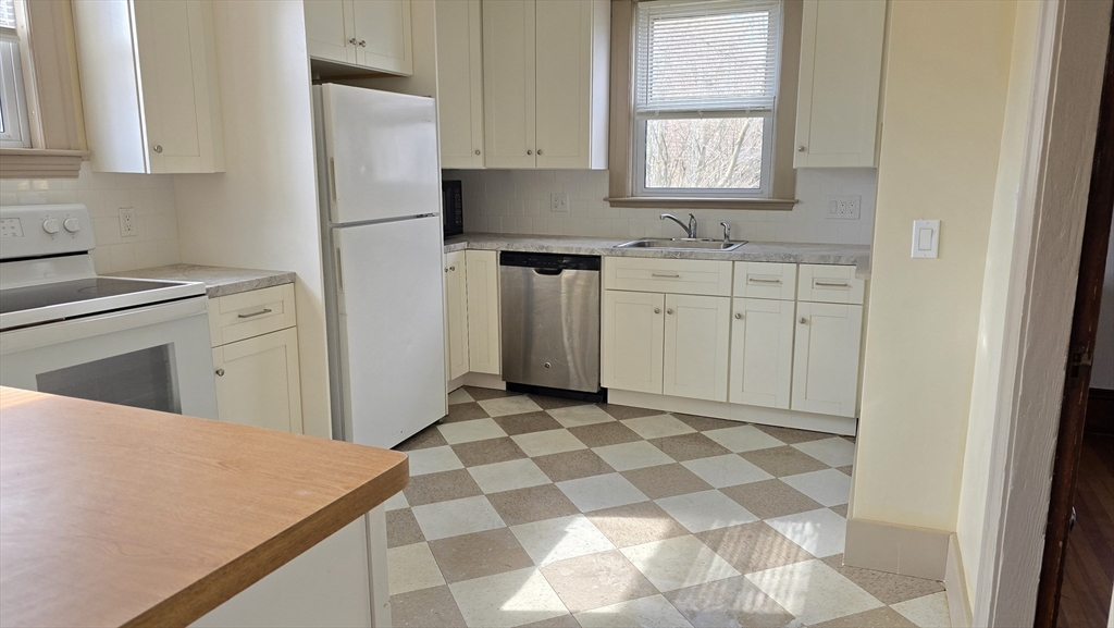 336 Burncoat Street Worcester, MA 01606 - Photo 13 of 40 a kitchen with a cabinets a sink and a window