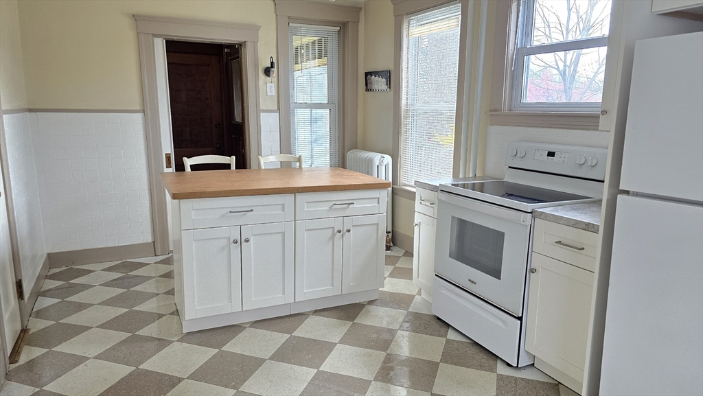 336 Burncoat Street Worcester, MA 01606 - Photo 14 of 40 a kitchen with a stove a sink and a refrigerator