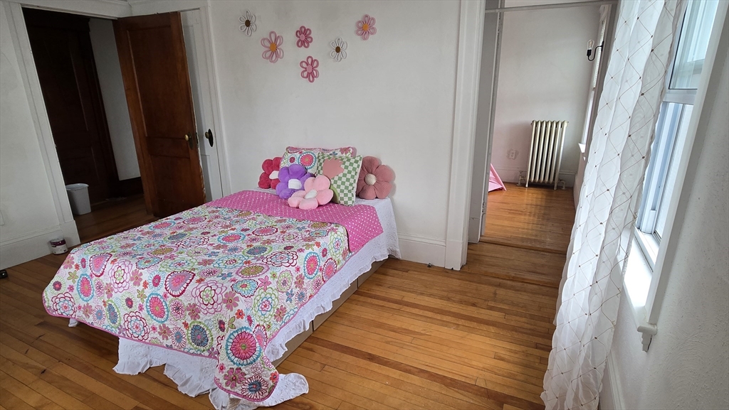 336 Burncoat Street Worcester, MA 01606 - Photo 24 of 40 a bedroom with a bed and a mirror
