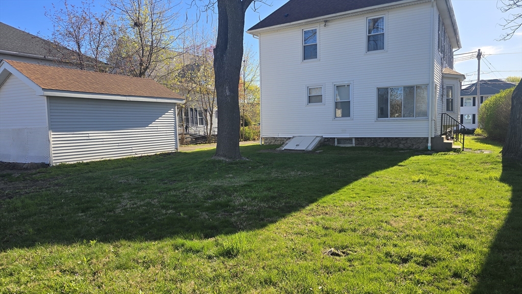 336 Burncoat Street Worcester, MA 01606 - Photo 38 of 40 a view of a backyard with plants and large tree