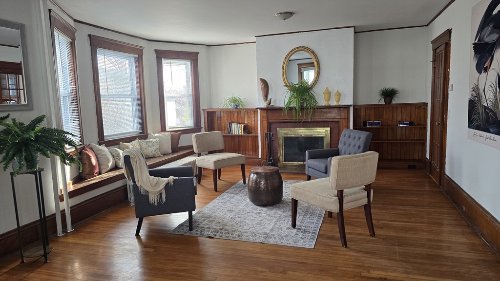 336 Burncoat Street Worcester, MA 01606 - Photo 5 of 40 a living room with furniture a window and a fireplace