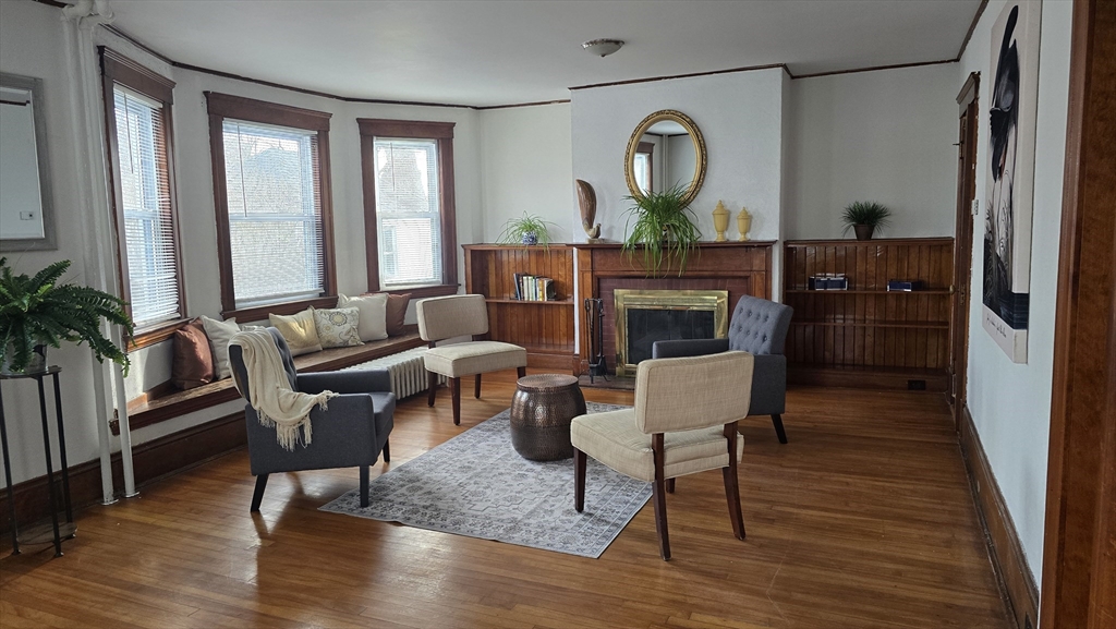 336 Burncoat Street Worcester, MA 01606 - Photo 7 of 40 a living room with furniture a large window and wooden floor