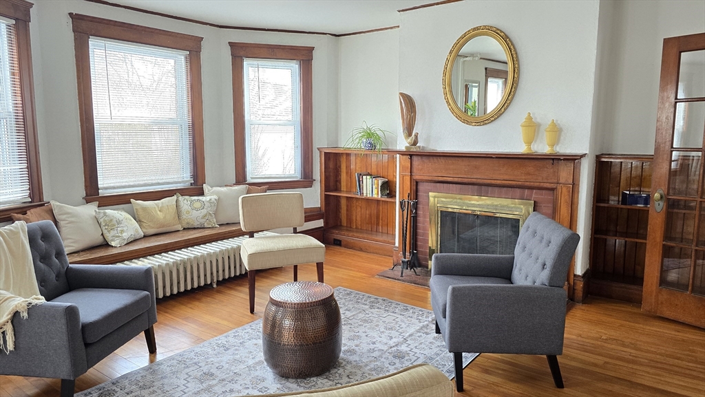 336 Burncoat Street Worcester, MA 01606 - Photo 8 of 40 a living room with furniture a fireplace and window
