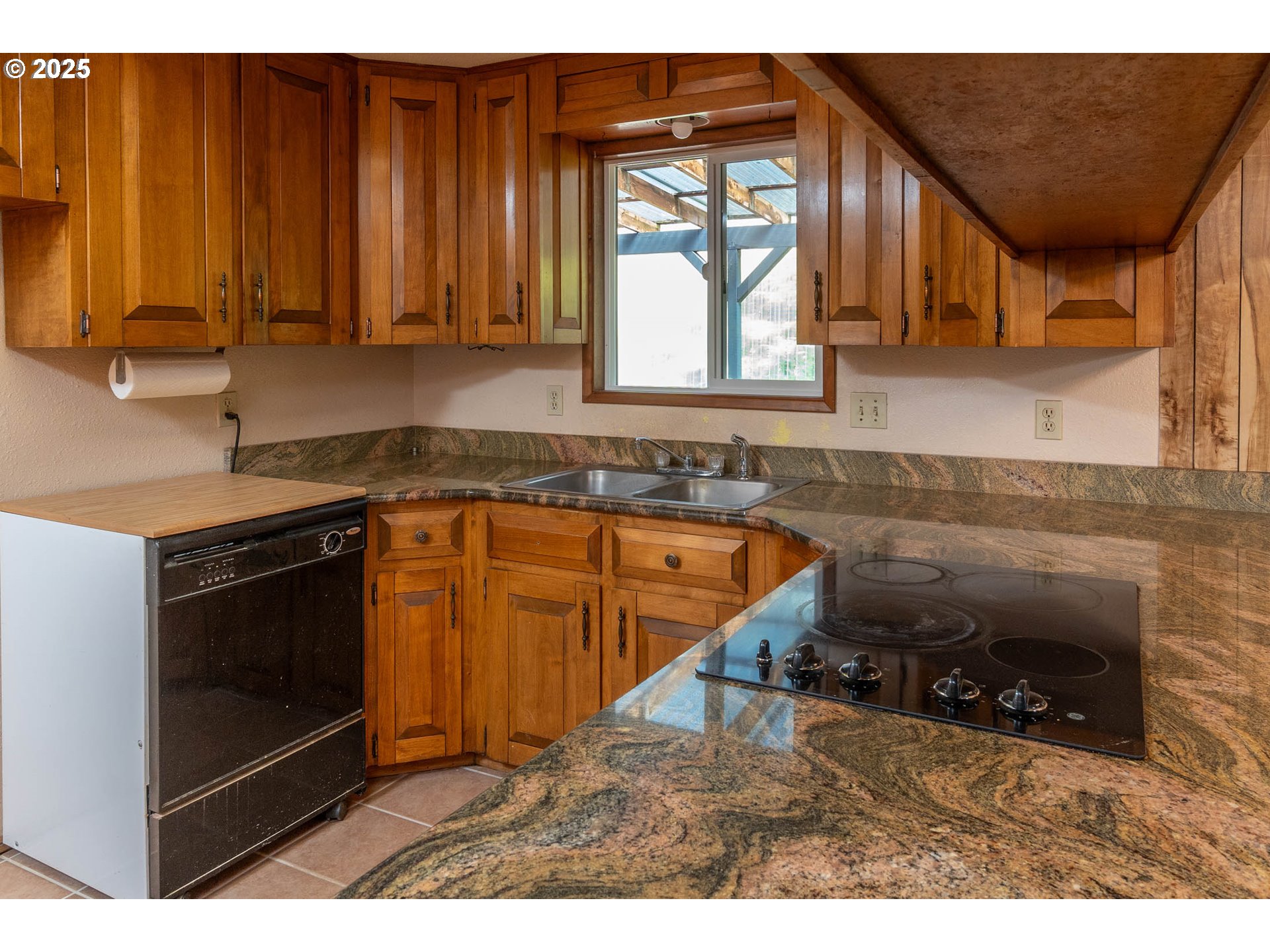 92433 Ward Creek Lane Myrtle Point, OR 97458 - Photo 11 of 38 a kitchen with wooden cabinets a sink and a stove