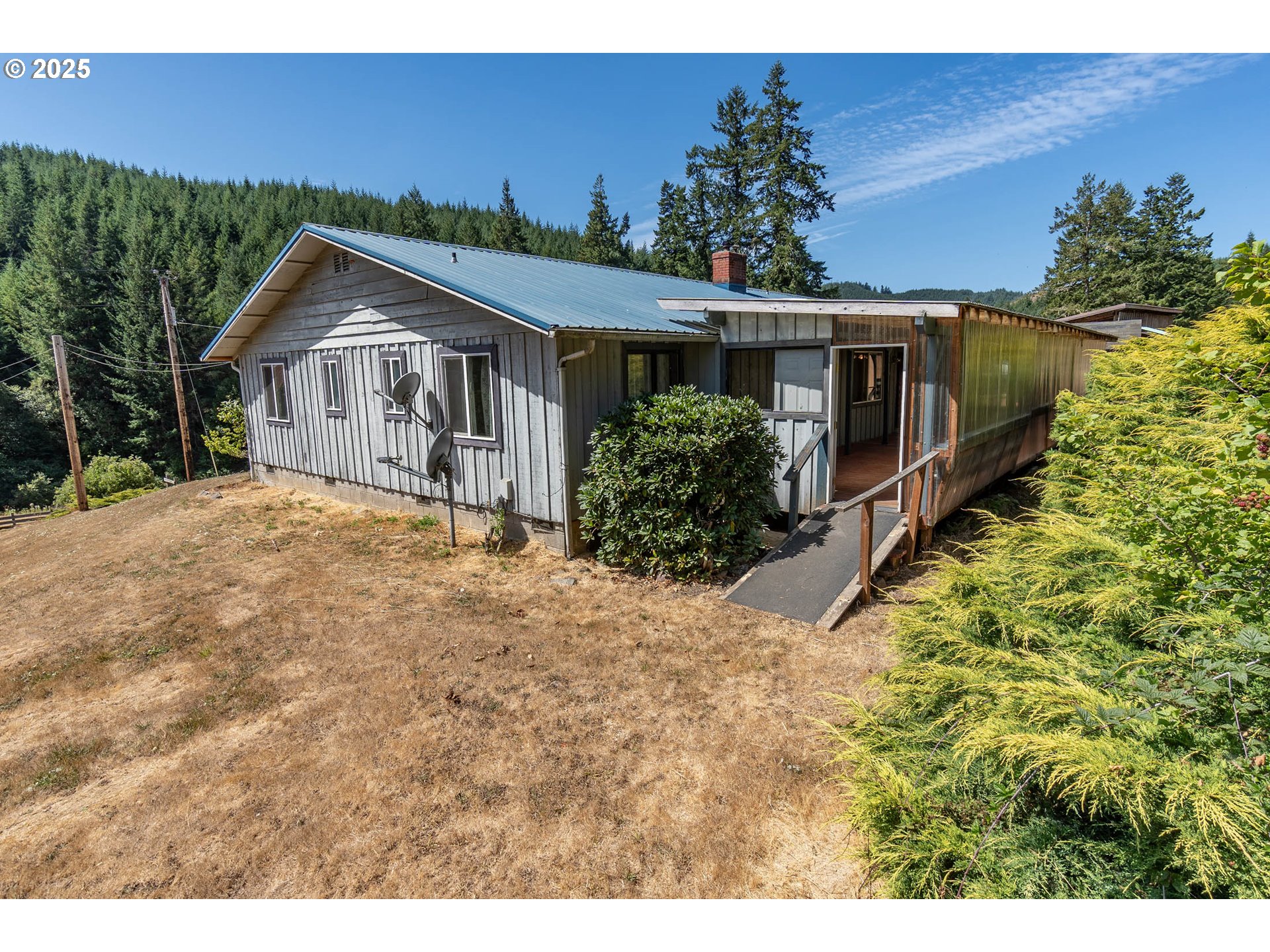 92433 Ward Creek Lane Myrtle Point, OR 97458 - Photo 3 of 38 a front view of house with yard and trees in the background