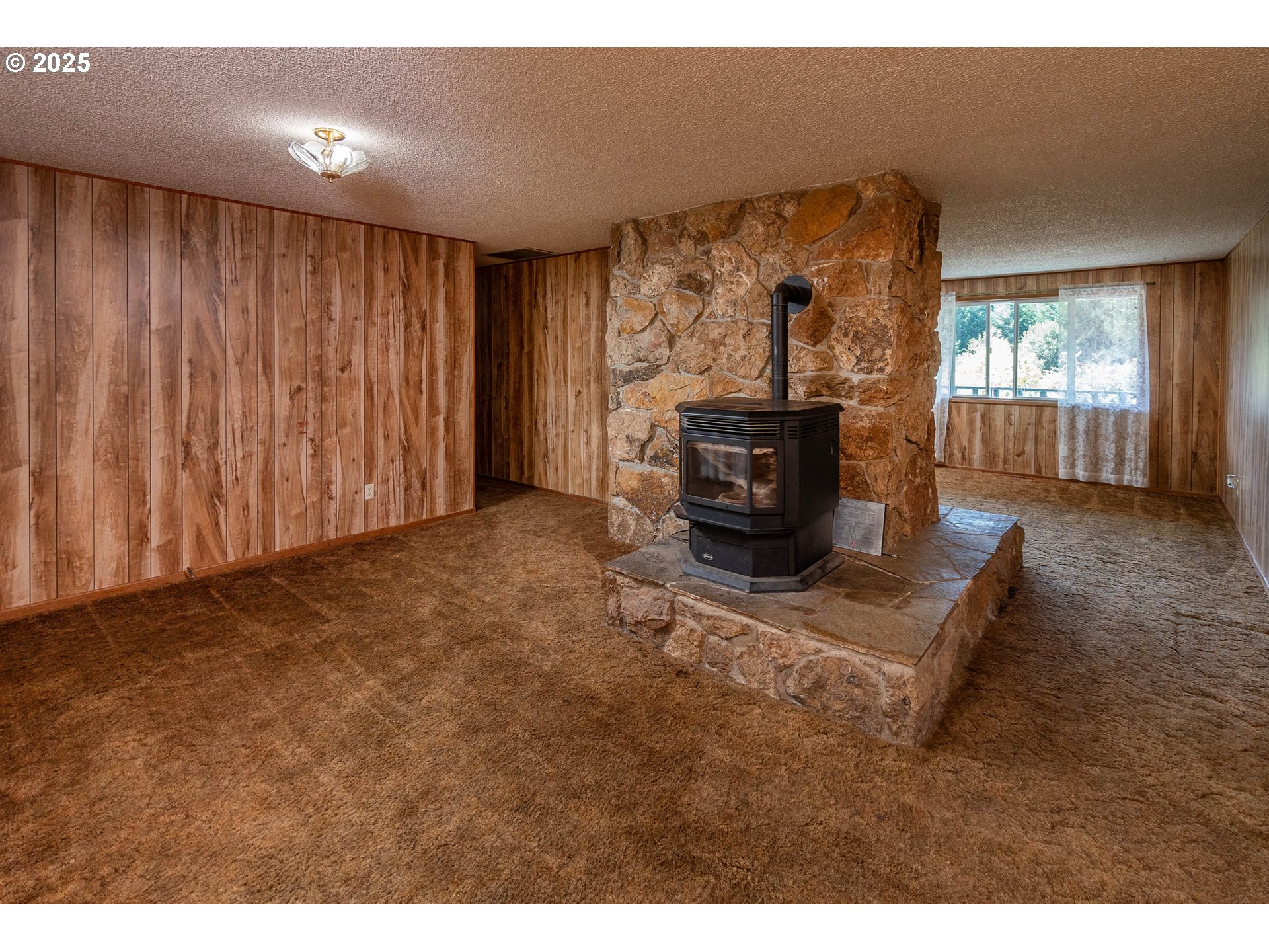 92433 Ward Creek Lane Myrtle Point, OR 97458 - Photo 7 of 38 a living room with furniture a fireplace and a flat screen tv