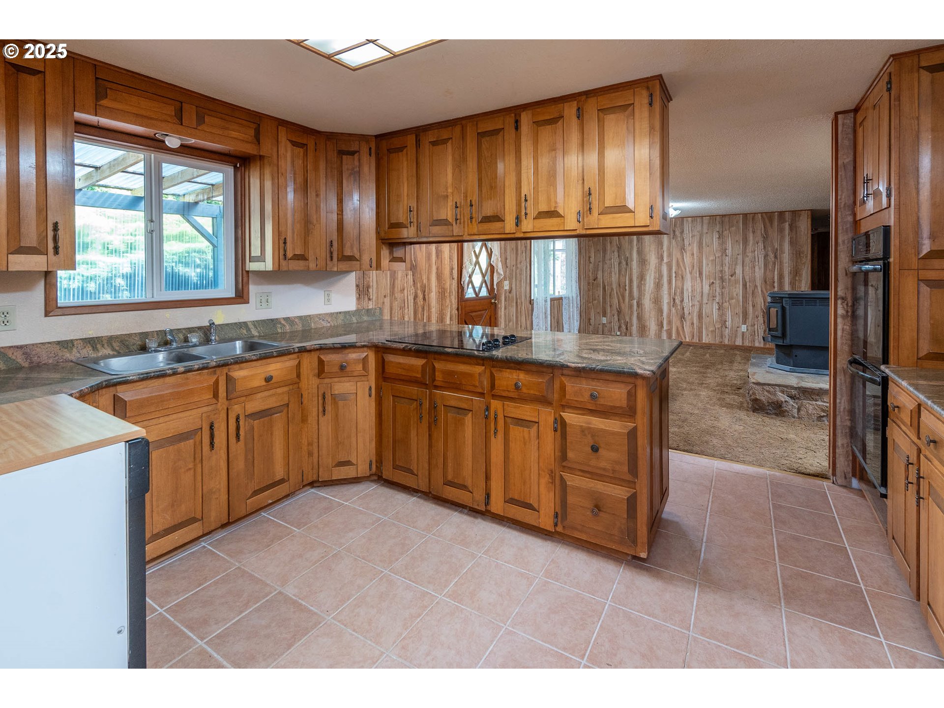 92433 Ward Creek Lane Myrtle Point, OR 97458 - Photo 10 of 38 a kitchen with a sink window and cabinets