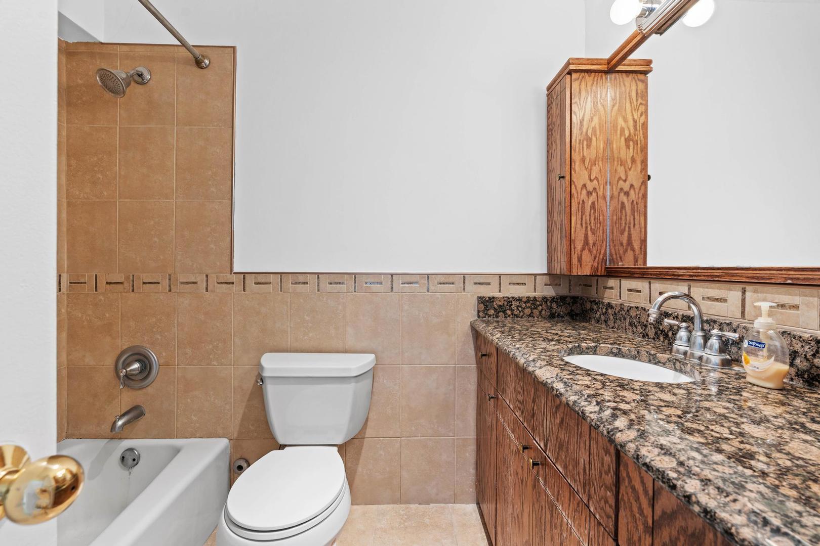5455 North Sheridan Road, Unit 3611 Chicago, IL 60640 - Photo 13 of 18 a bathroom with a granite countertop sink toilet and shower