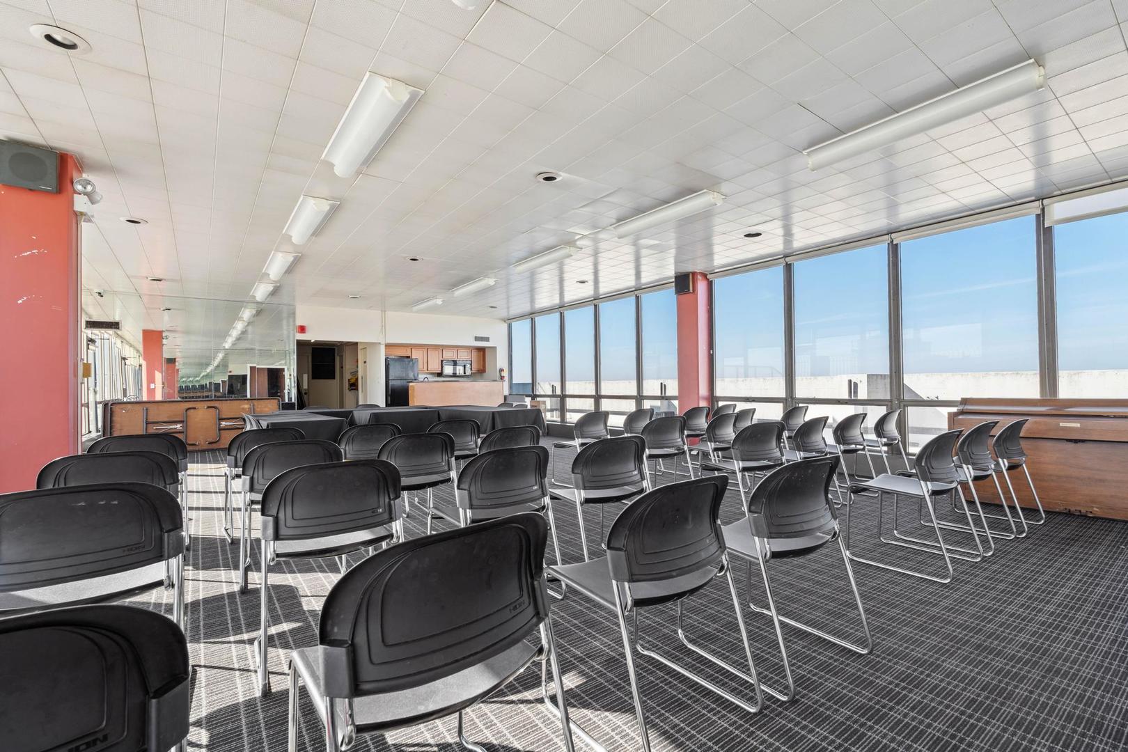 5455 North Sheridan Road, Unit 3611 Chicago, IL 60640 - Photo 17 of 18 a room with lots of chairs and a table