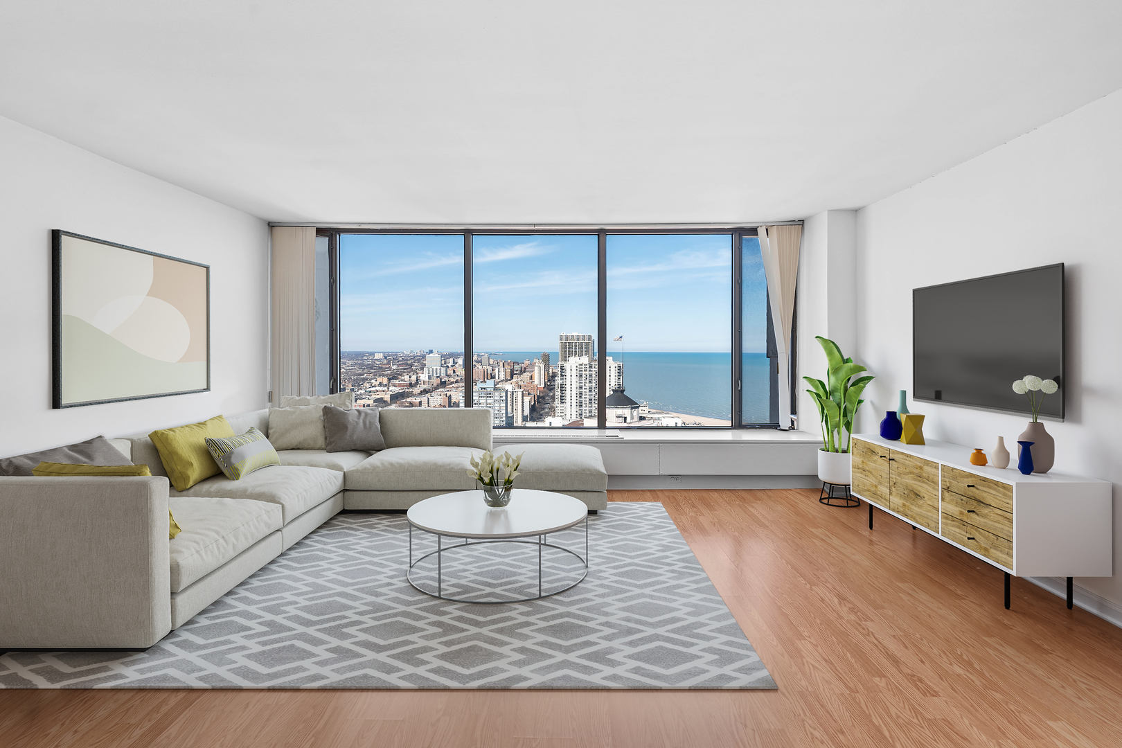 5455 North Sheridan Road, Unit 3611 Chicago, IL 60640 - Photo 3 of 18 a living room with furniture and a flat screen tv