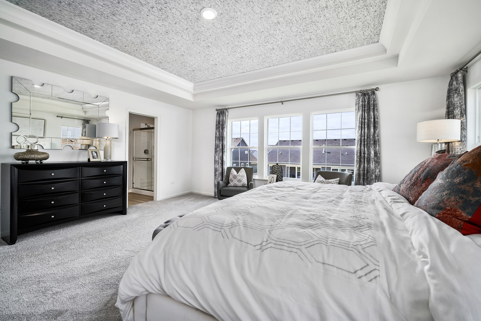 3664 Edelweiss Road Elgin, IL 60124 - Photo 24 of 31 a spacious bedroom with a bed and dresser with mirror