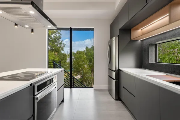a kitchen that has a sink and a stove