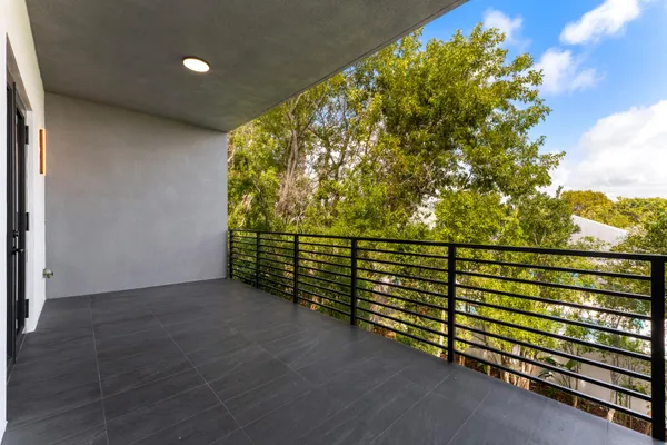 a view of two chairs in the balcony