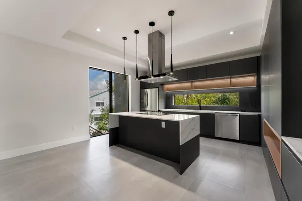 a view of a kitchen with a sink and a refrigerator