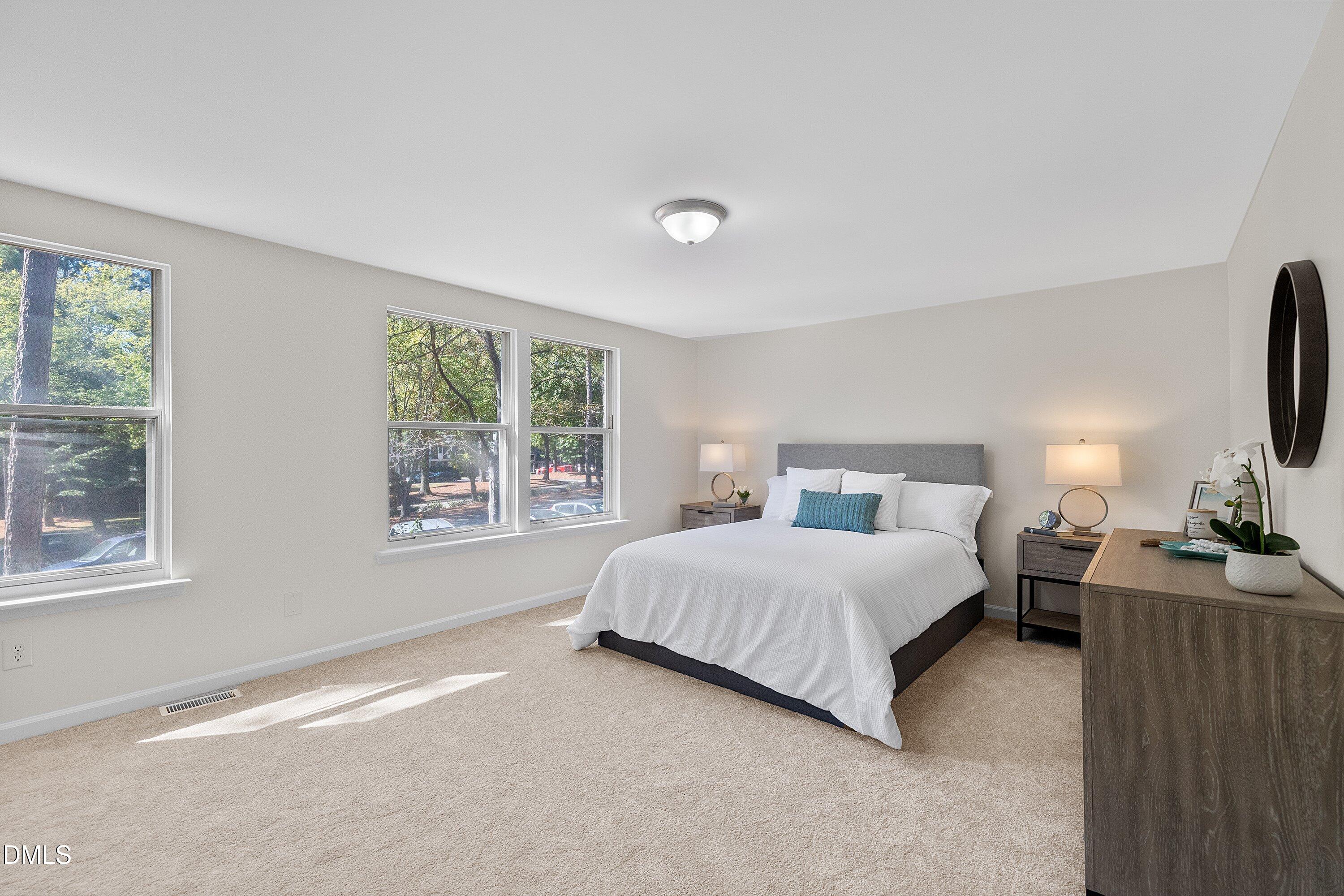 632 Middleton Avenue Cary, NC 27513 - Photo 21 of 34 a bedroom with a bed and a flat screen tv