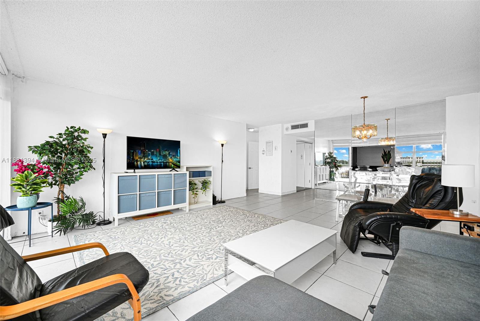 2100 Sans Souci Boulevard, Unit A509 North Miami, FL 33181 - Photo 14 of 44 a living room with furniture and a flat screen tv