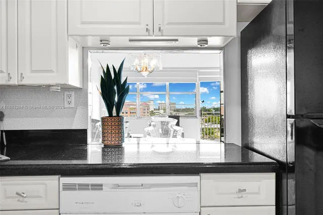 a kitchen with a refrigerator a oven and cabinets