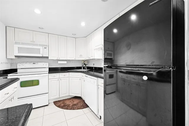 a kitchen with a cabinets and white appliances