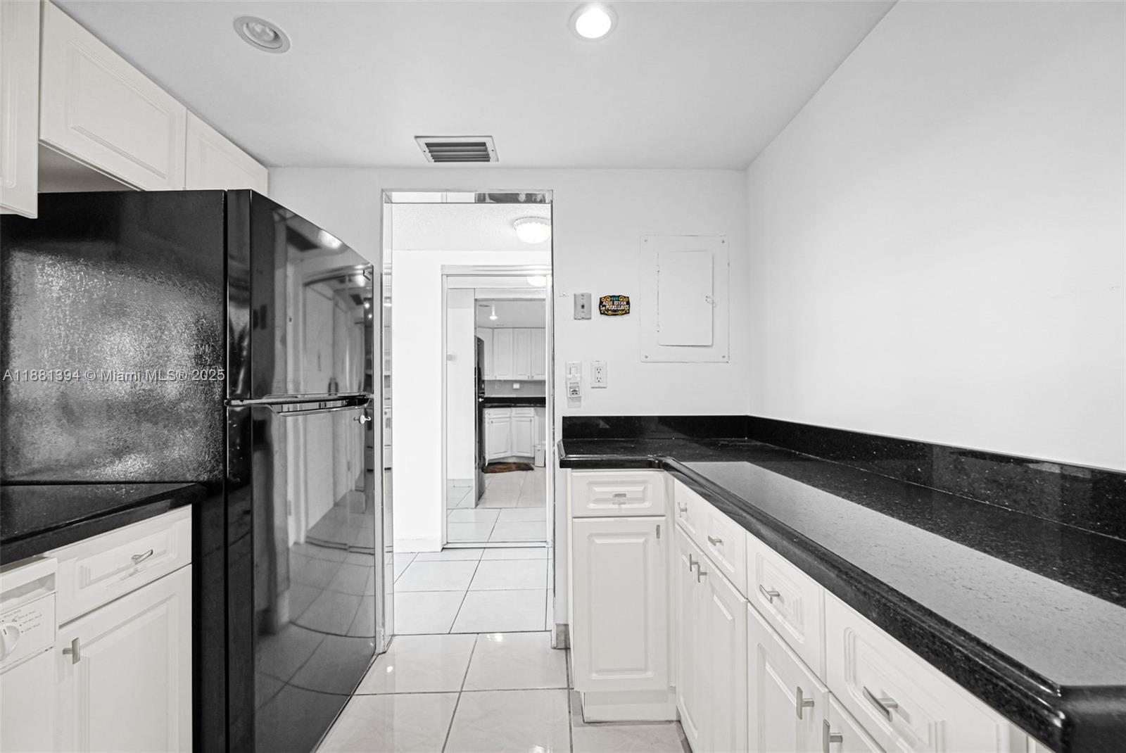 2100 Sans Souci Boulevard, Unit A509 North Miami, FL 33181 - Photo 19 of 44 a kitchen with a refrigerator and a stove top oven