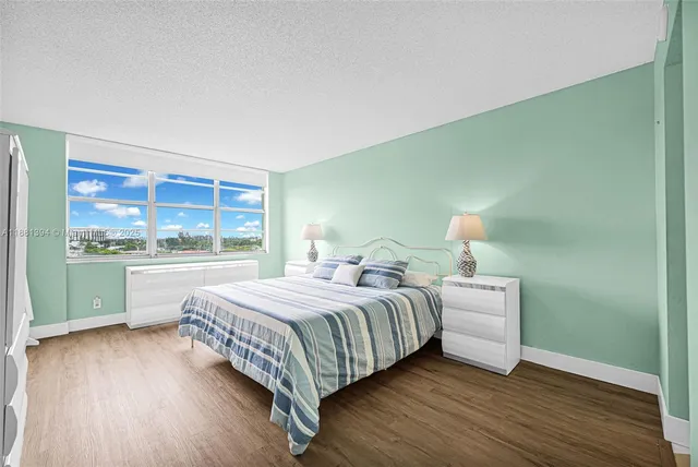 a bedroom with a bed and a large window