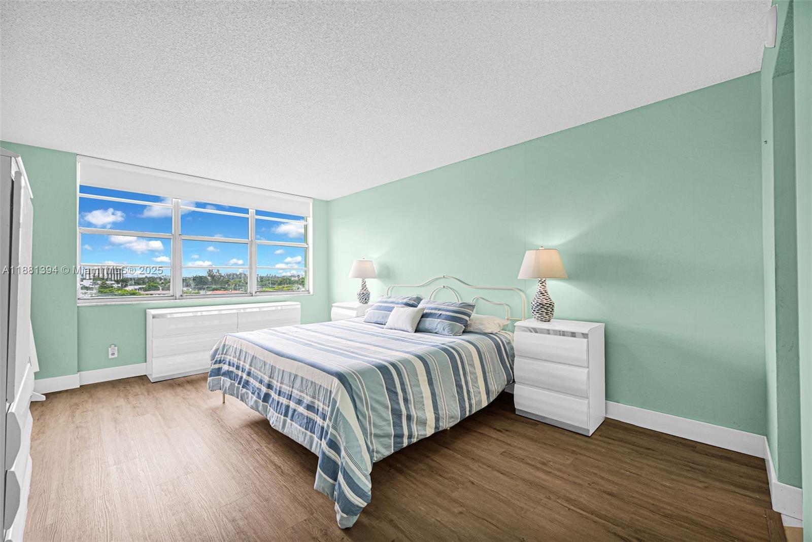 2100 Sans Souci Boulevard, Unit A509 North Miami, FL 33181 - Photo 23 of 44 a bedroom with a bed and a large window