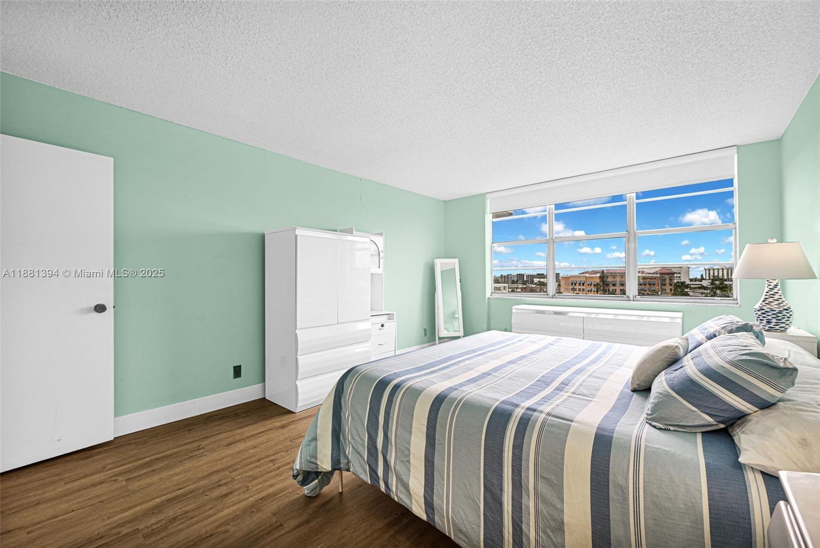 2100 Sans Souci Boulevard, Unit A509 North Miami, FL 33181 - Photo 24 of 44 a bedroom with a bed and a large window