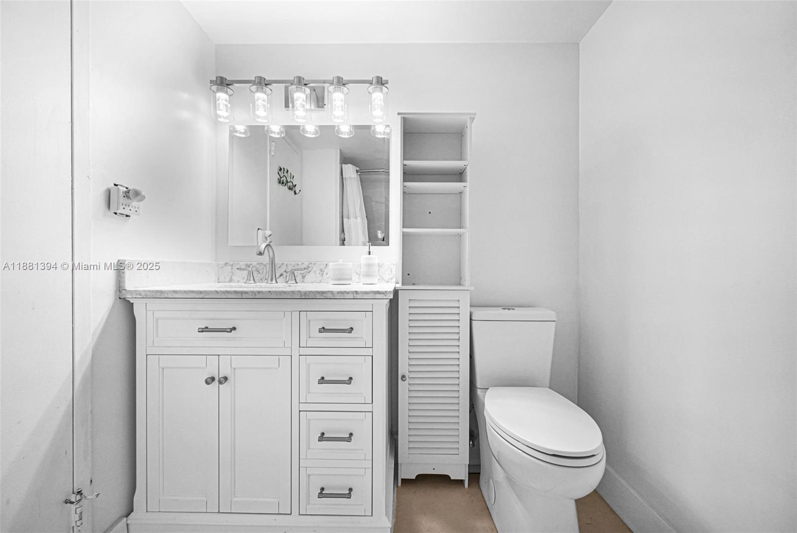 2100 Sans Souci Boulevard, Unit A509 North Miami, FL 33181 - Photo 27 of 44 a bathroom with a sink a toilet and large mirror