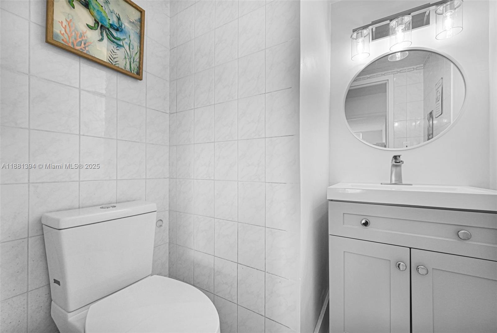 2100 Sans Souci Boulevard, Unit A509 North Miami, FL 33181 - Photo 30 of 44 a bathroom with a toilet sink and mirror