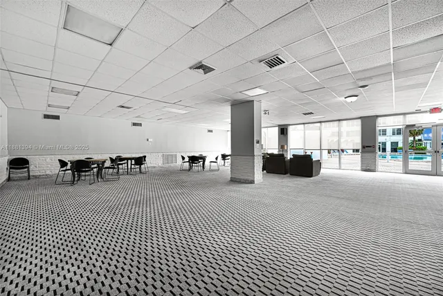 a big room with lots of furniture and a chandelier