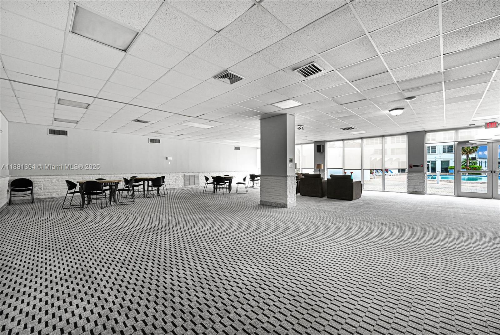 2100 Sans Souci Boulevard, Unit A509 North Miami, FL 33181 - Photo 33 of 44 a big room with lots of furniture and a chandelier