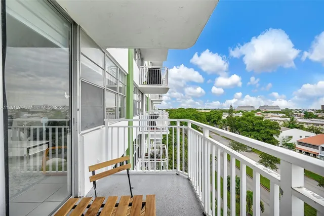 a view of a balcony with wooden chairs