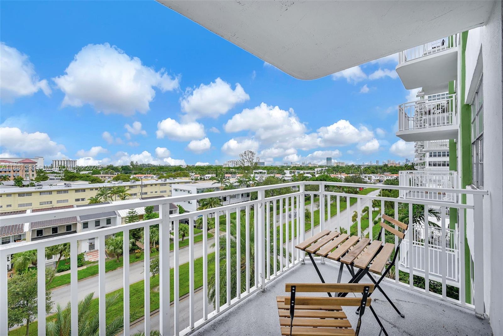 2100 Sans Souci Boulevard, Unit A509 North Miami, FL 33181 - Photo 10 of 44 a view of a chairs and table on the terrace