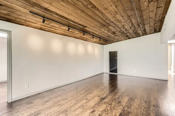 a view of a room with wooden floor