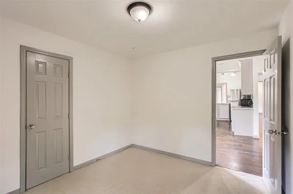 an empty room that has a wooden cupboard