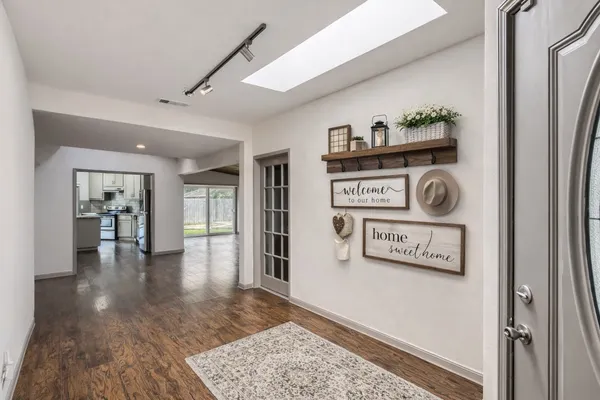 a view of a hallway with wooden floor and workspace
