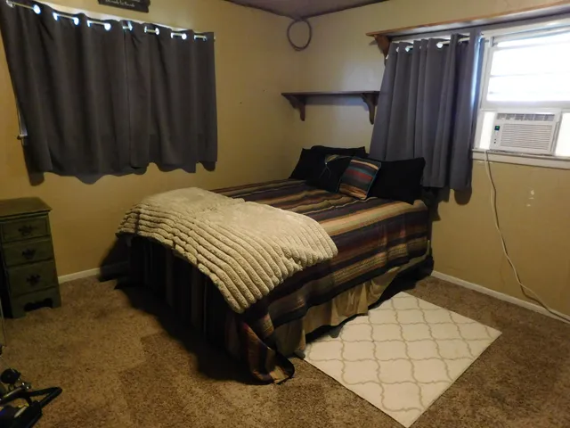 a bedroom with a bed and window