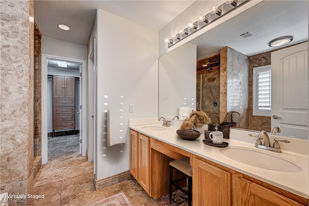 991 Ridge Path Avenue Henderson, NV 89015 - Photo 11 of 24 Bathroom with double vanity, visible vents, a sink