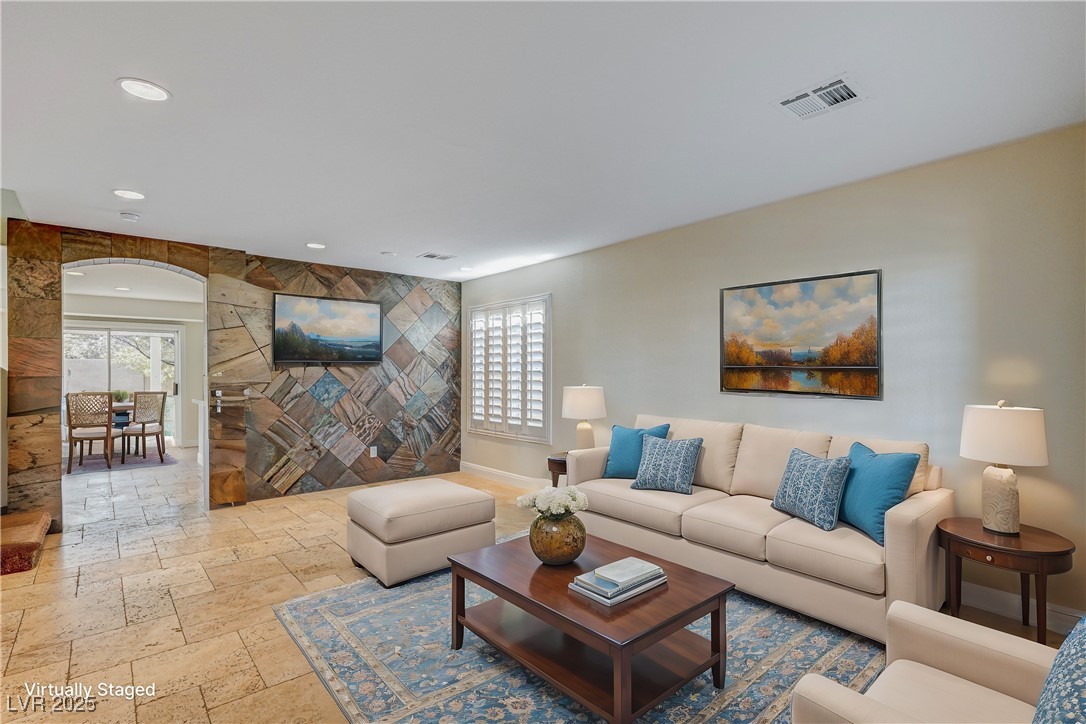 991 Ridge Path Avenue Henderson, NV 89015 - Photo 2 of 24 Living area featuring arched walkways, a wealth of