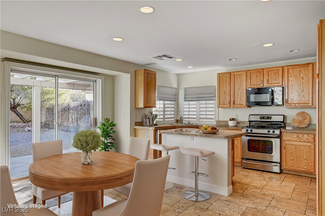 991 Ridge Path Avenue Henderson, NV 89015 - Photo 5 of 24 Kitchen with black microwave, recessed lighting, s