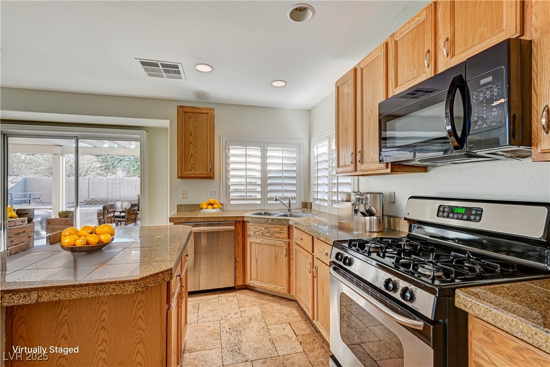 991 Ridge Path Avenue Henderson, NV 89015 - Photo 6 of 24 Kitchen featuring visible vents, tile countertops,