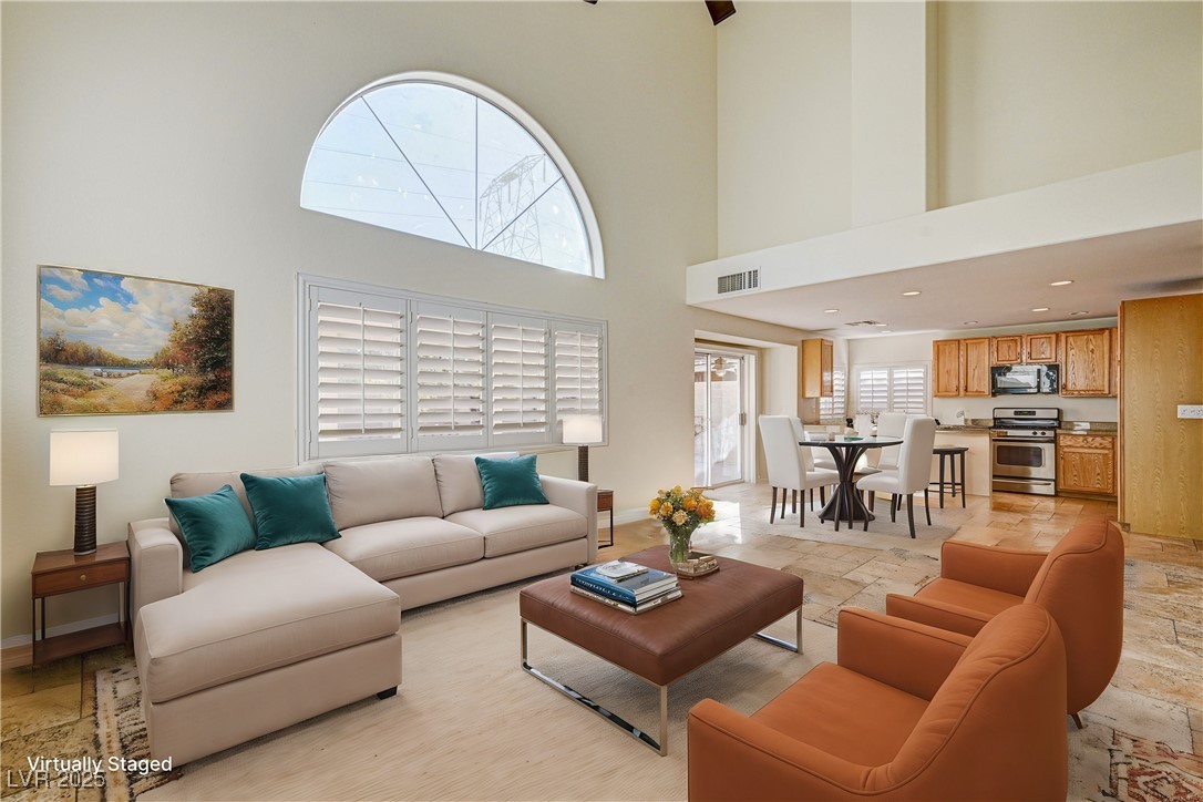 991 Ridge Path Avenue Henderson, NV 89015 - Photo 8 of 24 Living area with a high ceiling, stone tile floori