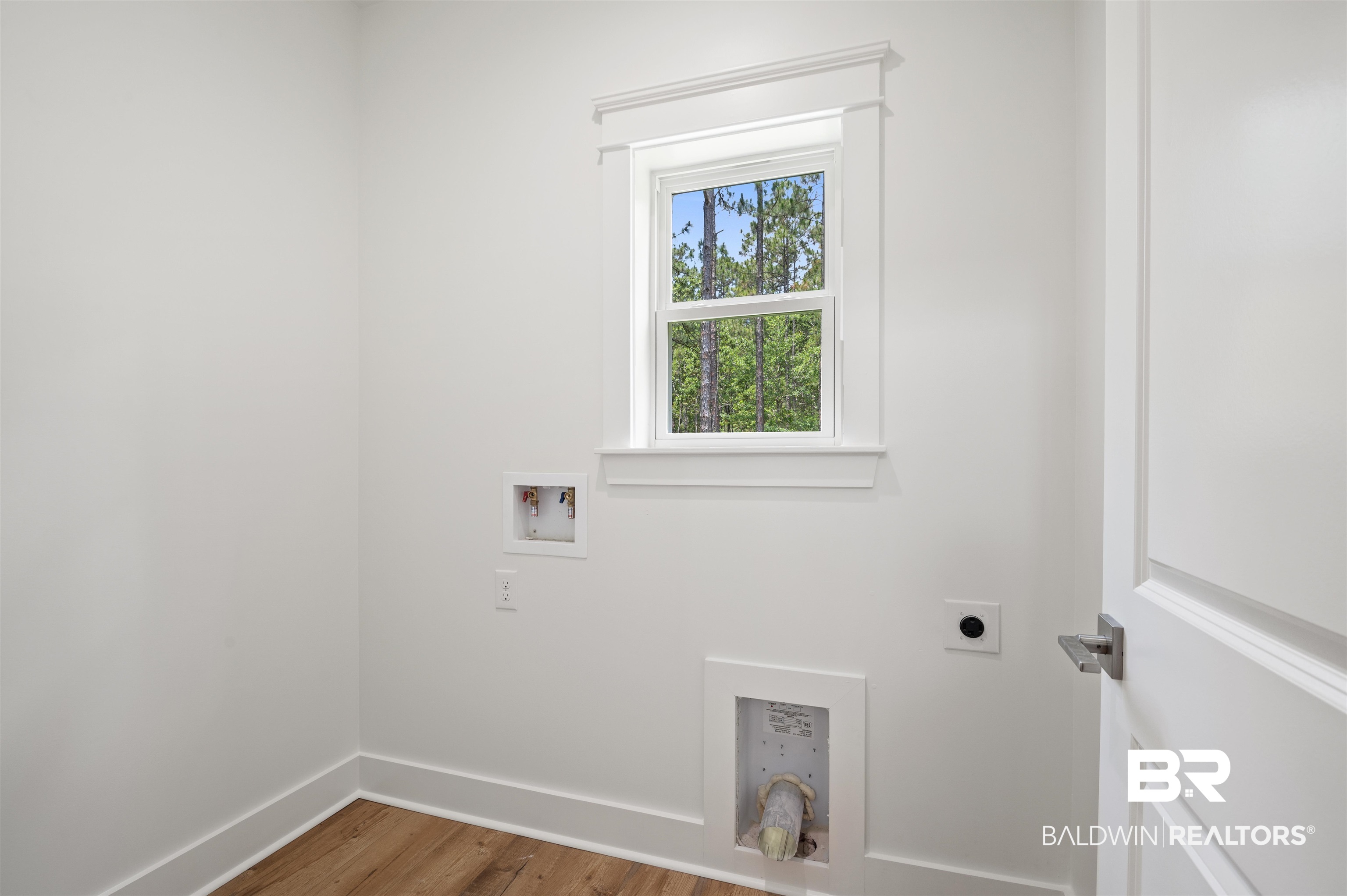 657 Island Way Gulf Shores, AL 36542 - Photo 24 of 59 Laundry area featuring electric dryer hookup, wood finished floors, baseboards, and hookup for a washing machine