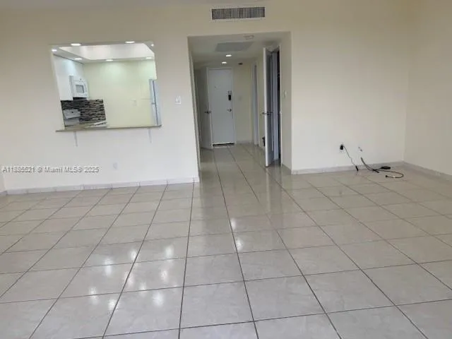 a view of a livingroom with an empty space and a window