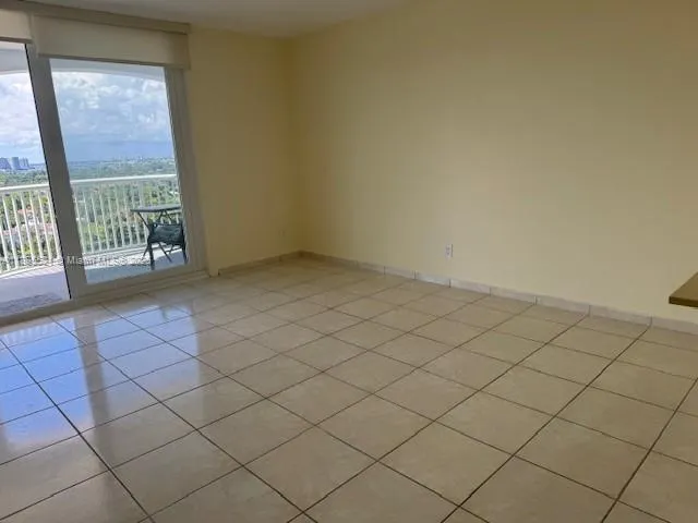 a view of an empty room and a window