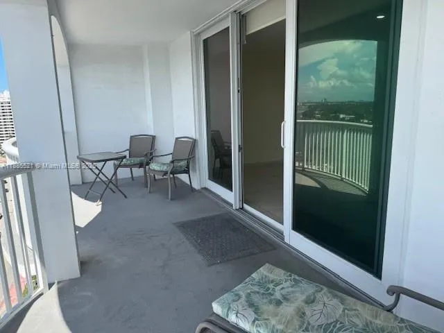 a view of a hallway with furniture and a window