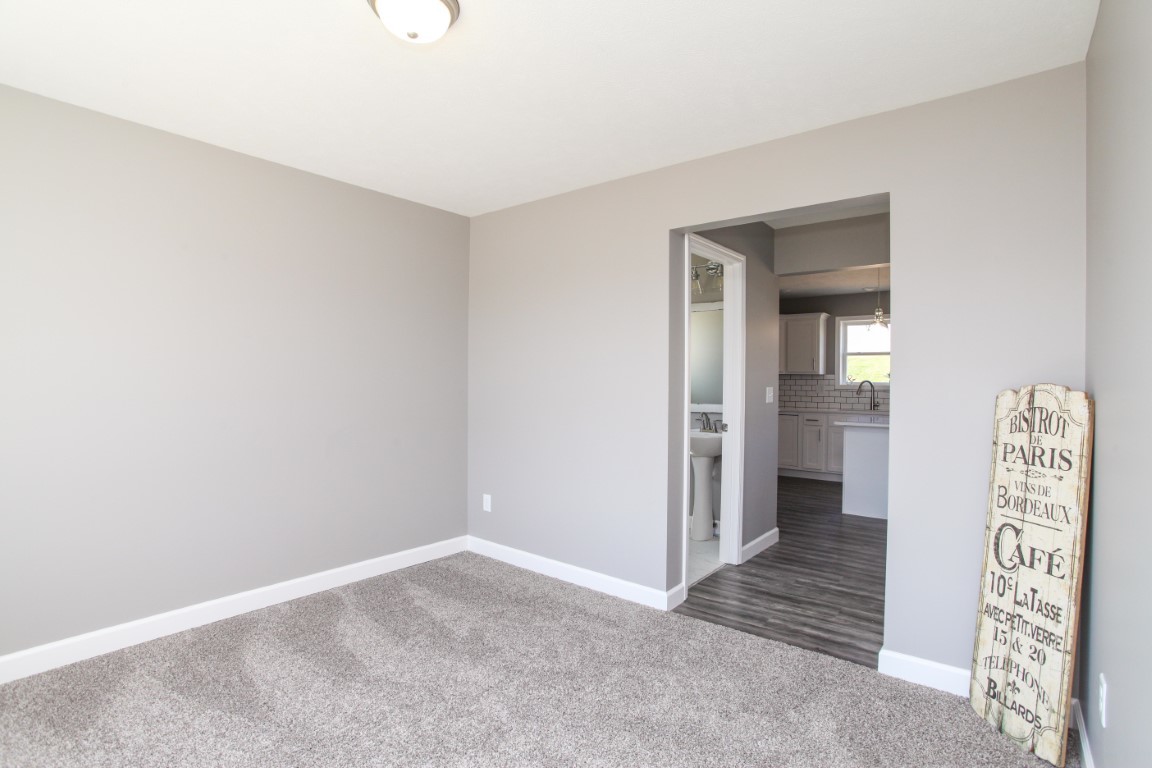 2238 Heather Ridge Drive Normal, IL 61761 - Photo 11 of 26 an empty room with a hallway and wooden floor