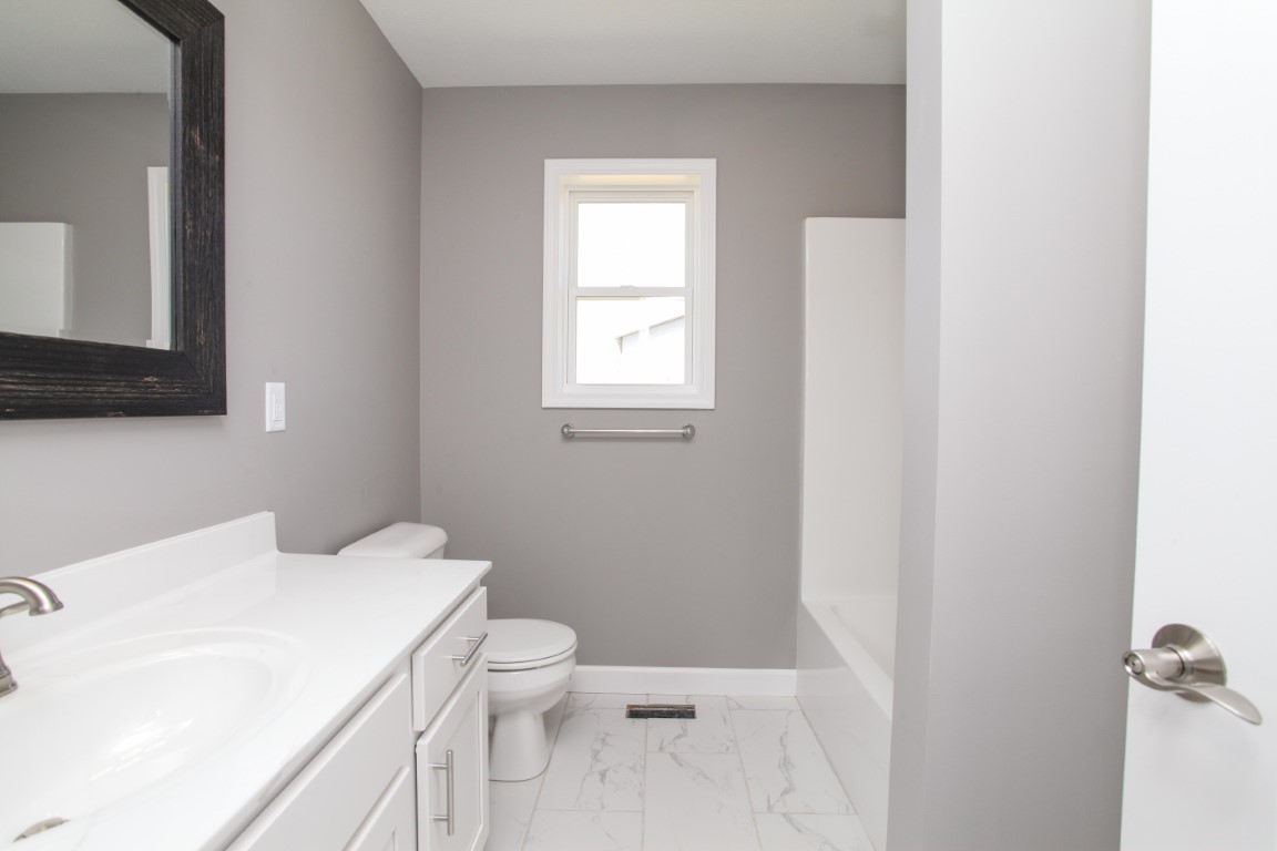 2238 Heather Ridge Drive Normal, IL 61761 - Photo 16 of 26 a bathroom with a sink a toilet and a mirror