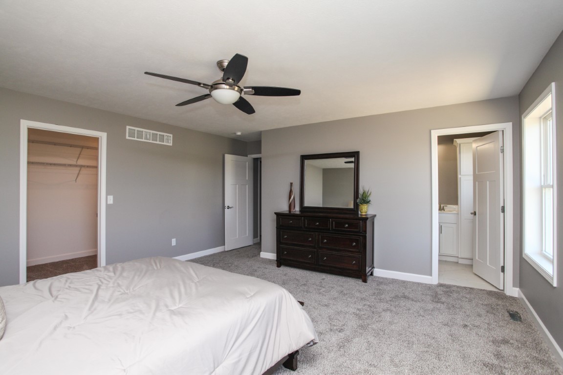 2238 Heather Ridge Drive Normal, IL 61761 - Photo 18 of 26 a bedroom with a bed and a dresser
