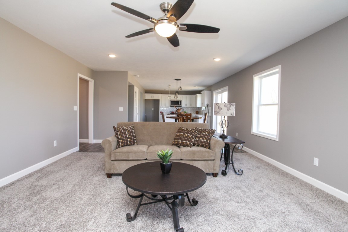 2238 Heather Ridge Drive Normal, IL 61761 - Photo 4 of 26 a living room with furniture and a chandelier