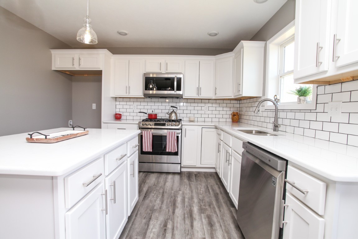 2238 Heather Ridge Drive Normal, IL 61761 - Photo 5 of 26 a kitchen with stainless steel appliances a sink dishwasher a stove top oven a refrigerator with white cabinets and wooden floor